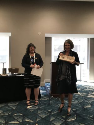 Past-Chair Deb Mollen presenting Oksana Yakushko with the Woman of the Year award